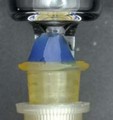 Side view of leakage in a ceramic coated tip syringe at the connection of the syringe tip and the needle hub during vaccine preparation and administration. The blue area represents higher volume loss.