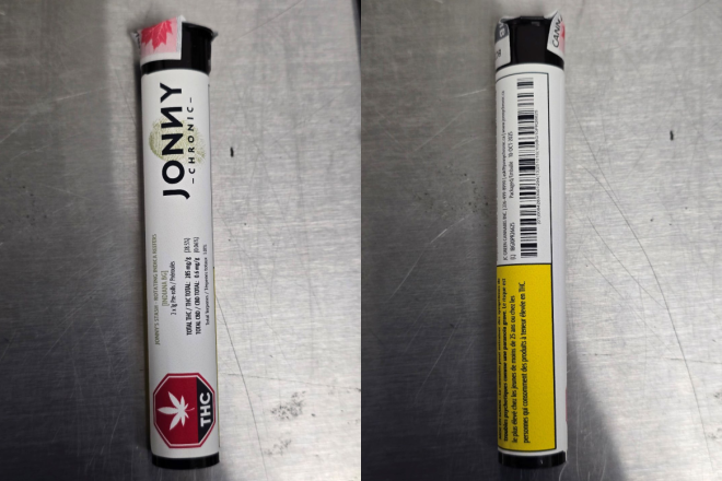A product in a tube with a white label with a red octagon-shaped standardized cannabis symbol and yellow Health Warning Box on the bottom. A logo is next to the cannabis symbol. The label also has product information like the name, cannabinoid content and bar codes.