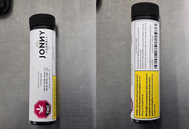 A product in a tube with a white label with a red octagon-shaped standardized cannabis symbol and yellow Health Warning Box on the bottom. A logo is next to the cannabis symbol. The label also has product information like the name, cannabinoid content and bar codes.