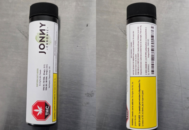 A product in a tube with a white label with a red octagon-shaped standardized cannabis symbol and yellow Health Warning Box on the bottom. A logo is next to the cannabis symbol. The label also has product information like the name, cannabinoid content and bar codes.