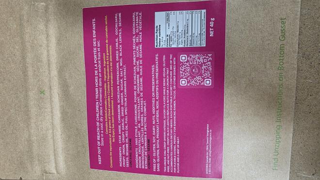 Front of packaging of coloured pouch with a red octagon-shaped standardized cannabis symbol on the top left corner and yellow Health Warning Box on the bottom. A logo is on the top right corner. The middle of the label has product information like the name and cannabinoid content.